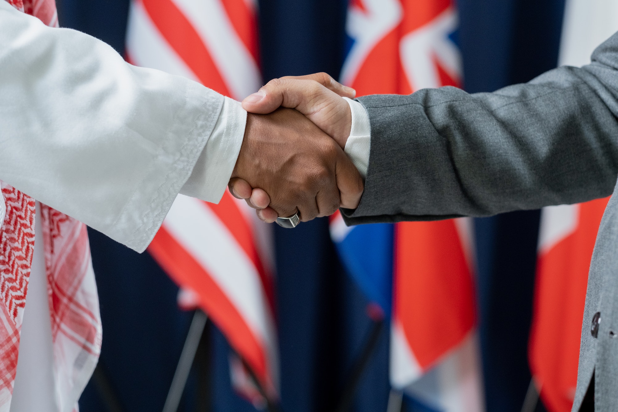 Two contemporary male delegates or political leaders shaking hands