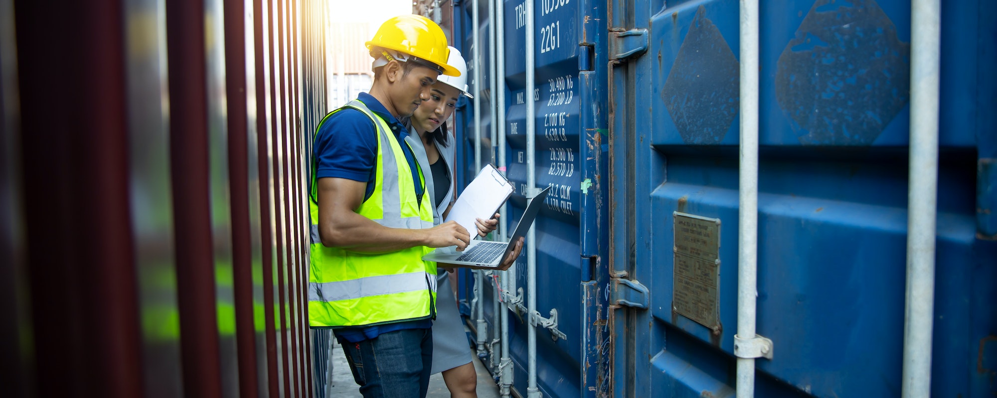 businesspeople or engineer check goods in industrial container, transport and logistics