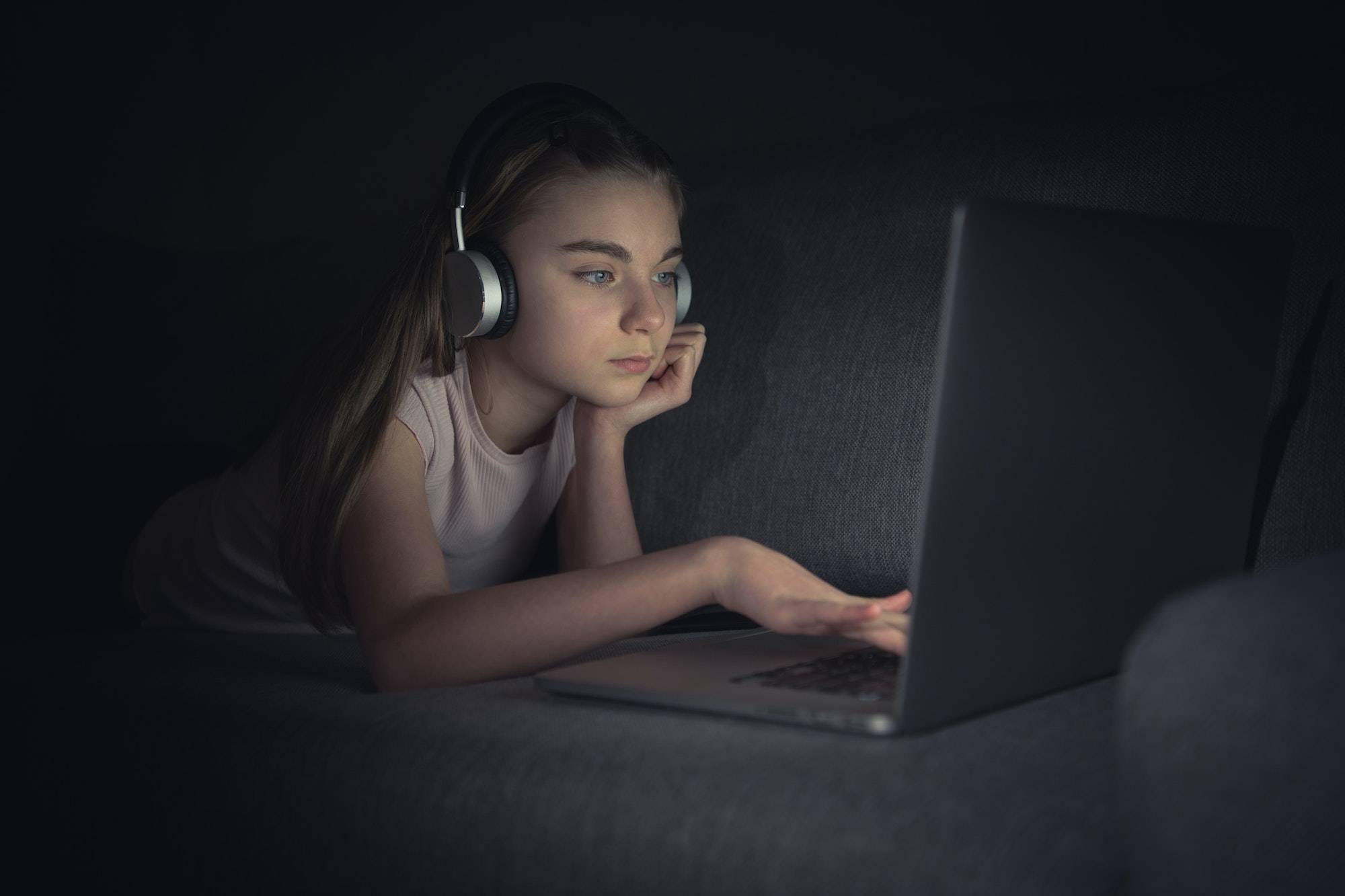 Girl Browsing Internet on Her Laptop and Using Headphones