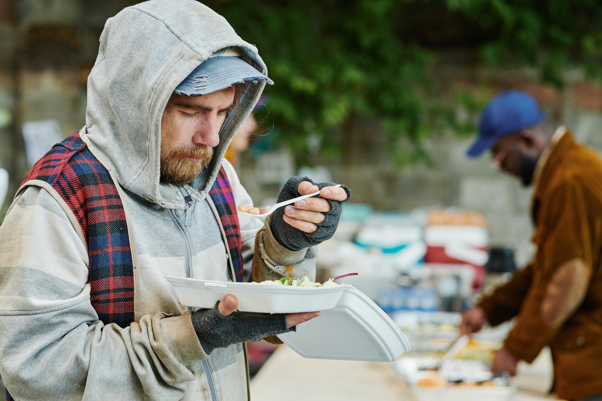Homeless man eating charity food