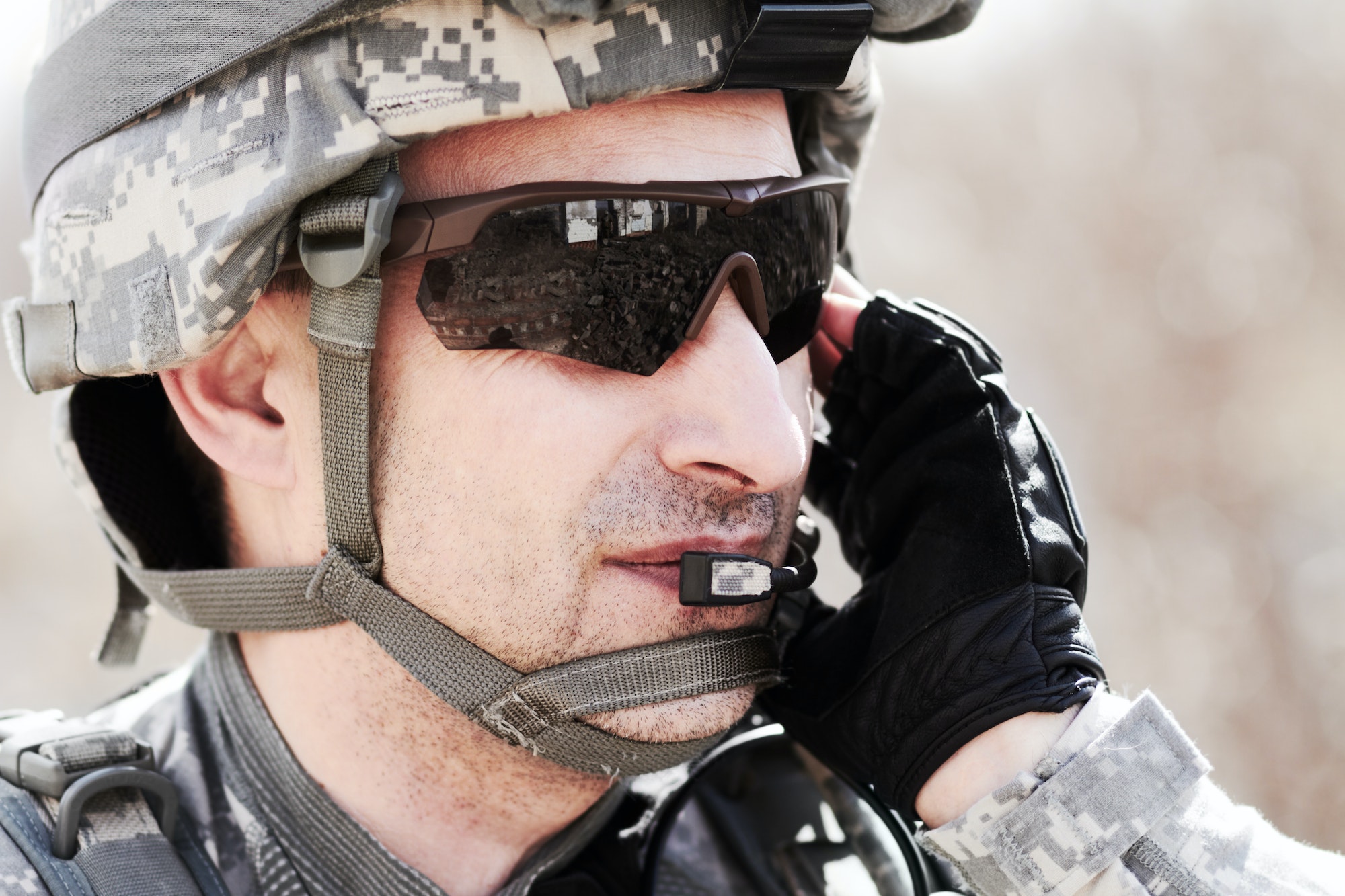 Keeping communication on command. Closeup profile of a soldier communicating on his headset.