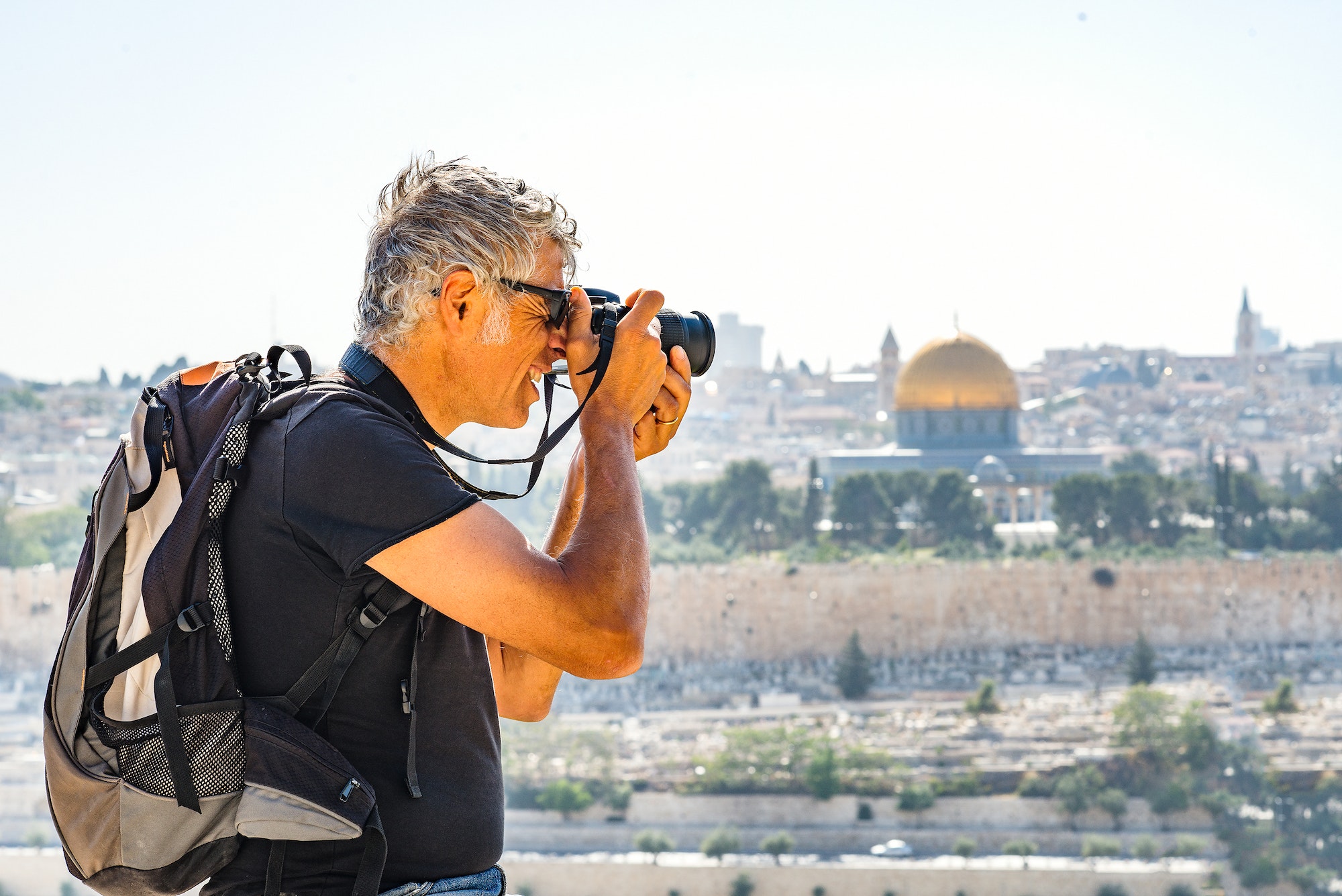 Man photographing tourists in Jerusalem