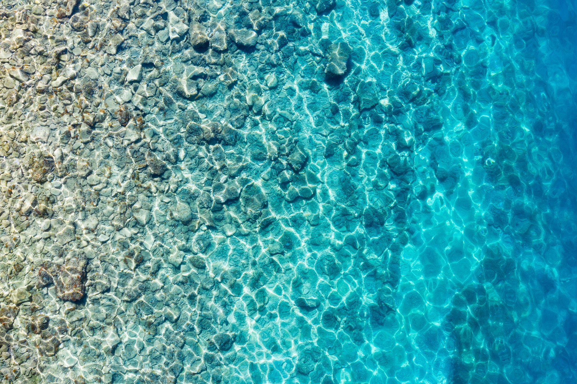Mediterranean sea. Aerial view on water and rocks. Transparent water. Vacation and adventure.