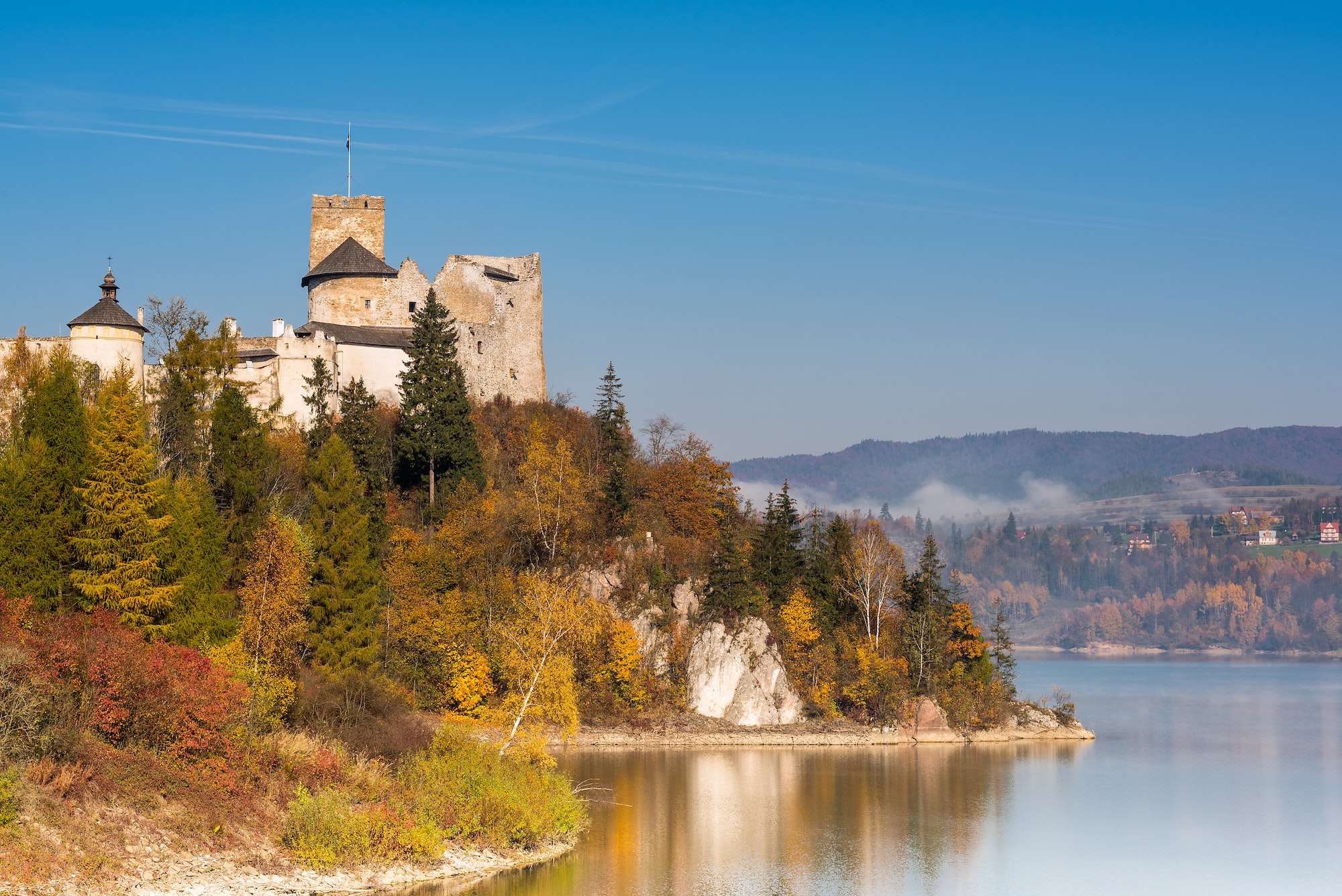 Nidzica Castle over lake in Poland