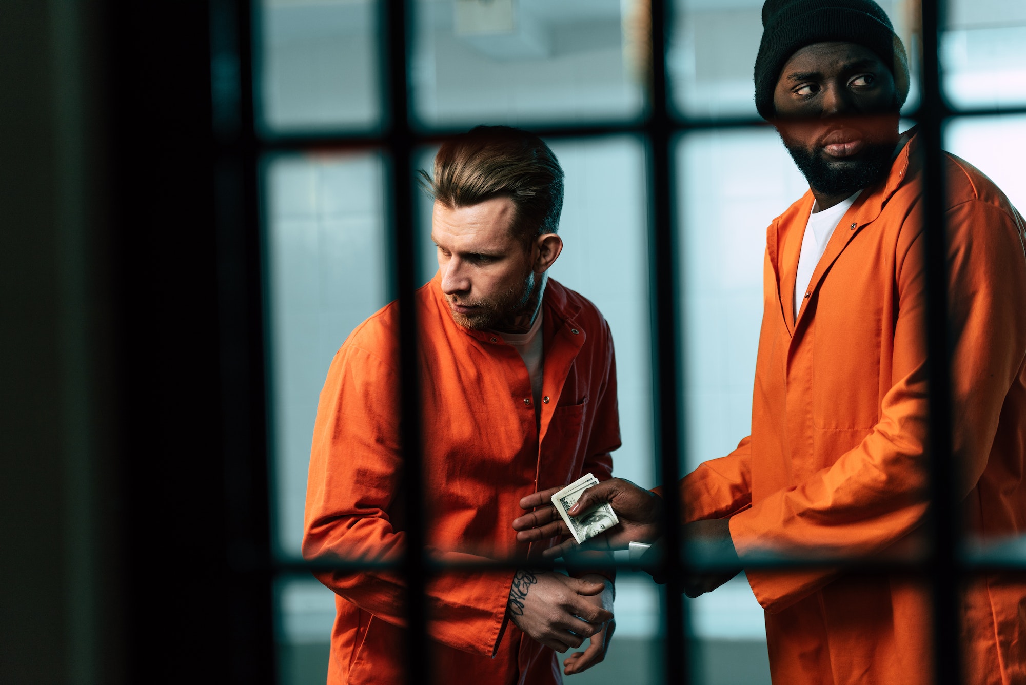 prisoner buying drugs at african american inmate in prison room